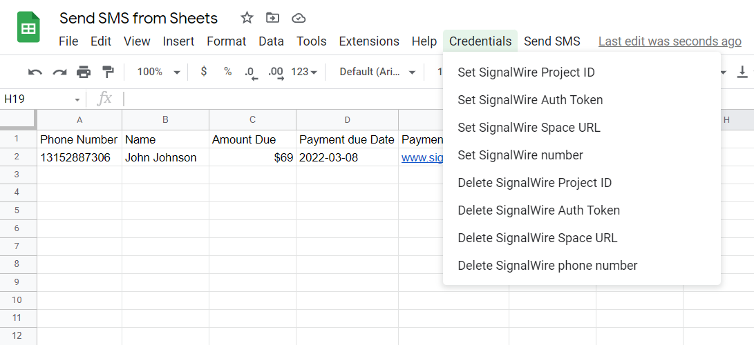 A screenshot of the Google Sheets UI. In the menu bar after Help, the new menu bar items Credentials and Send SMS have been added. 'Credentials' has been selected, allowing the user to set or delete the SignalWire Project ID, Auth Token, Space URL, and phone number.