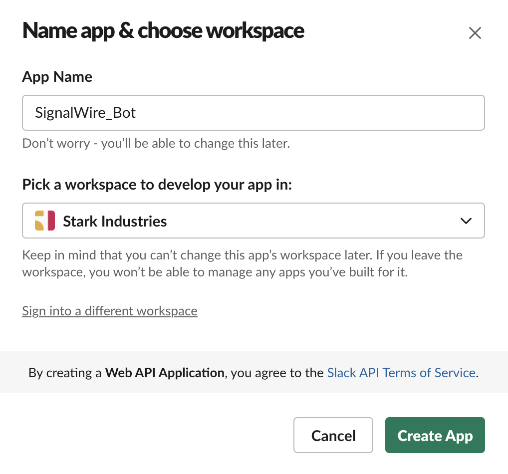 A screenshot of the Create New App popup in Slack. There is a text field for the App Name, which is set to SignalWire_Bot. There is also a dropdown menu titled Pick a Workspace to develop your app in, which is set to Stark Industries.